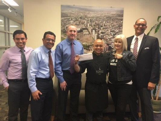 Chocolatier Romeo Garcia receiving check from Long Beach officials