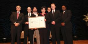 The NIST team holding their award aside Deputy Secretary Andrews.