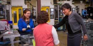 Secretary Pritzker talks with employees of the Leatherman Tool Group, Inc during a tour