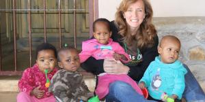 Laura Lane with Swazi children at the Heart of Africa orphanage